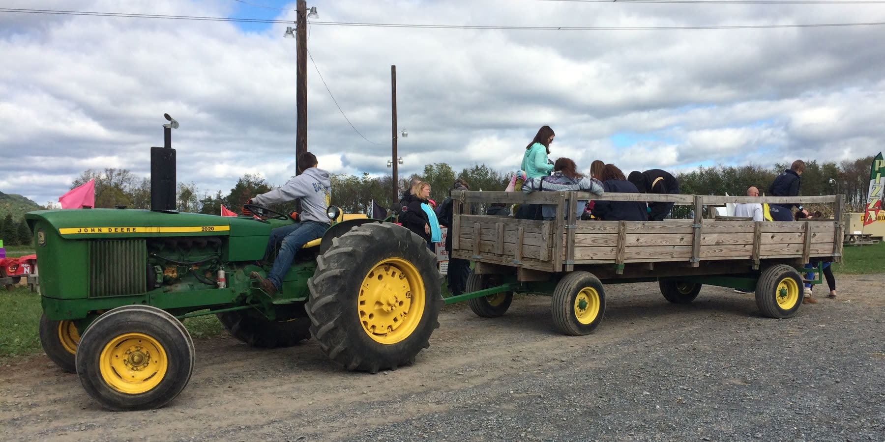 The hay wagon loaded with visitors behind the tractor