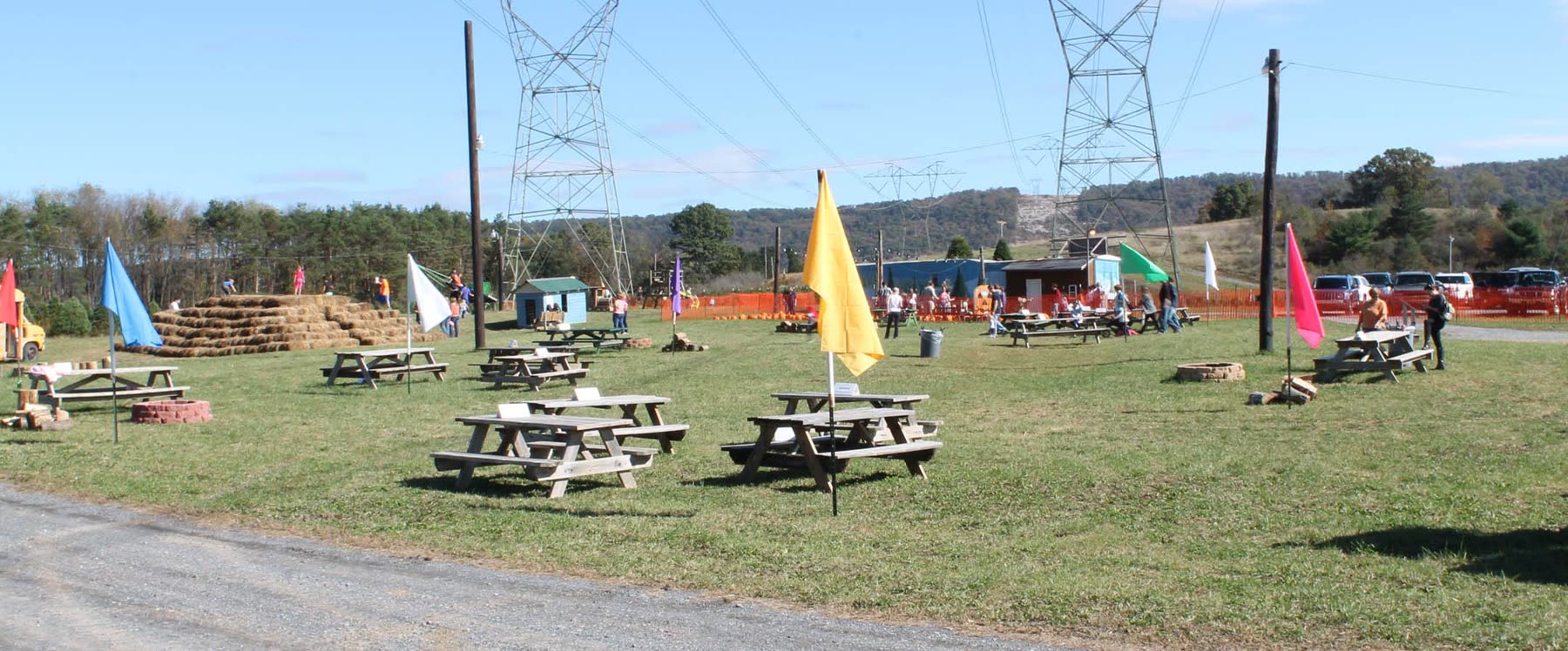 Picnic tables, flags and the hay pyramid on the Fall Frenzy grounds